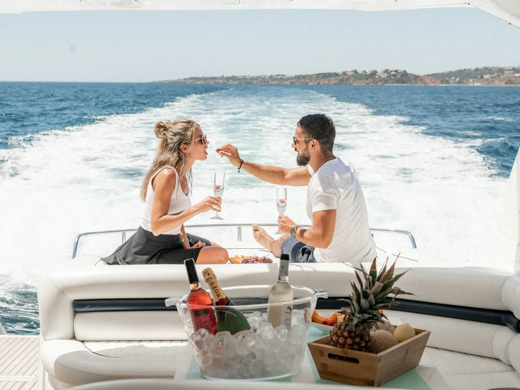 couple sitting on white boat during daytime